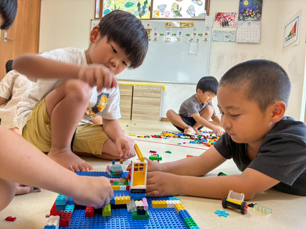 友だちと同じ土台を囲んで作品を作る様子