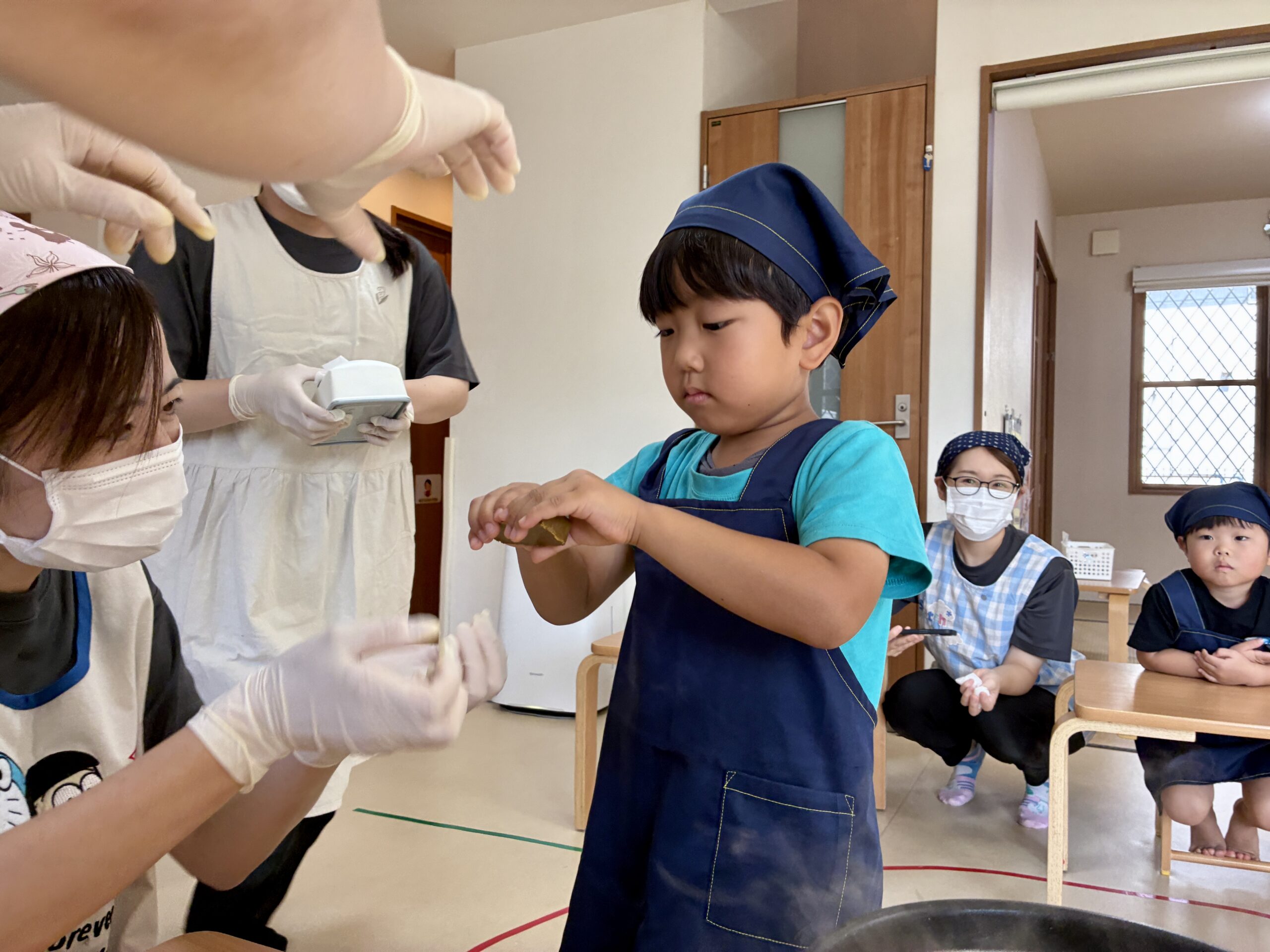 両手でカレールーを割るこども